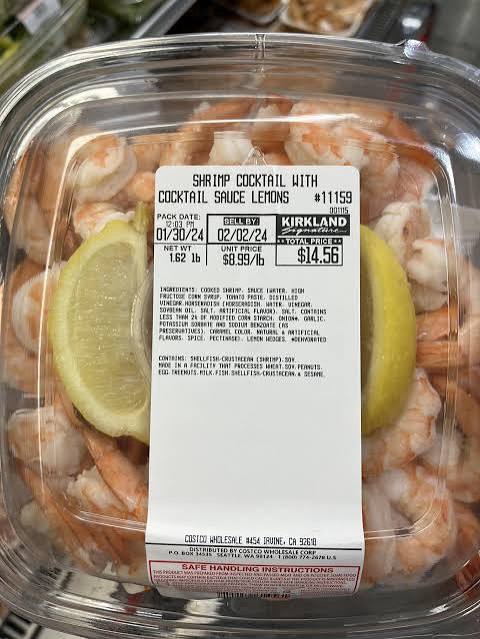 Costco deli shrimp cocktail platter with cocktail sauce and lemon wedges