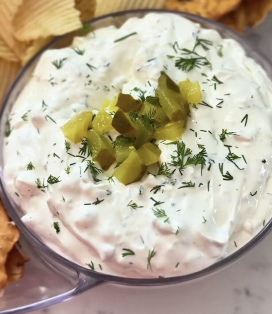 Pickle Dip Recipe (Creamy Dill Pickle Cream Cheese Dip) 1 pickle dip recipe in a glass bowl with diced pickles and fresh dill on top