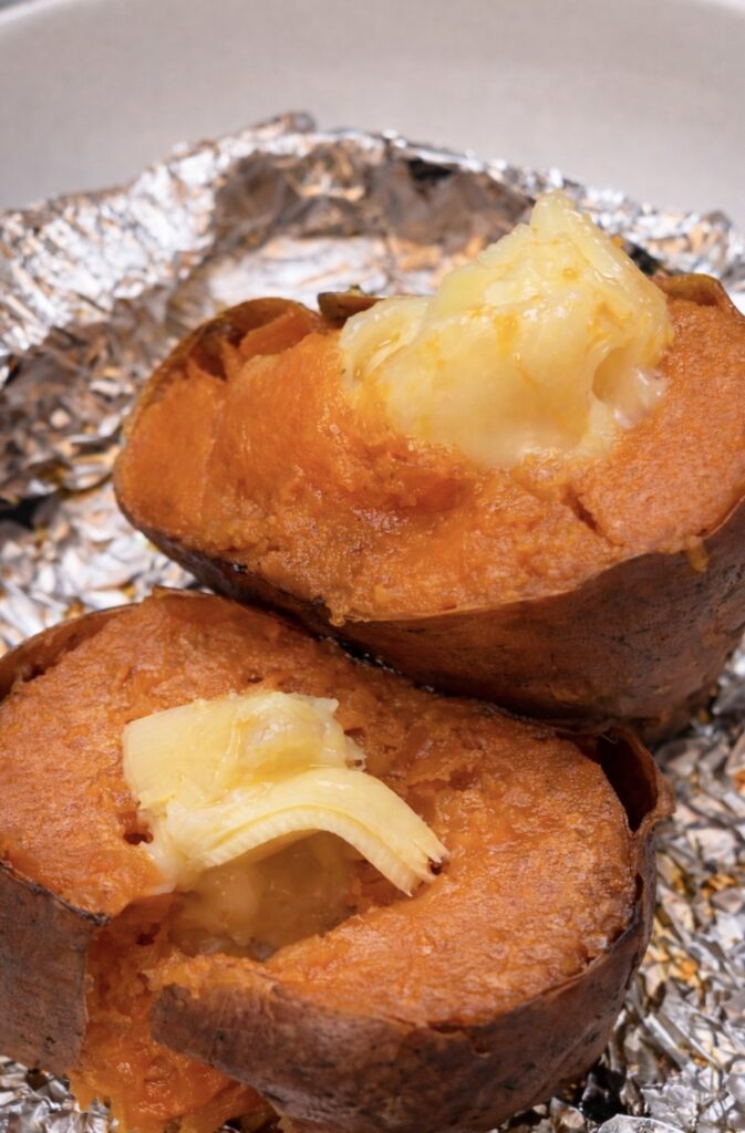 Roasted sweet potato with melty cheese recipe – best cheese for sweet potato melting over two slow-roasted sweet potatoes, showing the viral TikTok roasted sweet potato melty cheese recipe