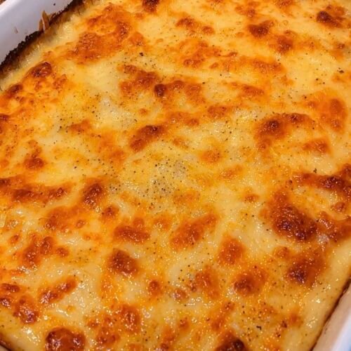 Au gratin potatoes with golden bubbling cheese in a baking dish