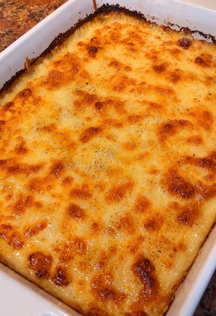Au gratin potatoes with golden bubbling cheese in a baking dish