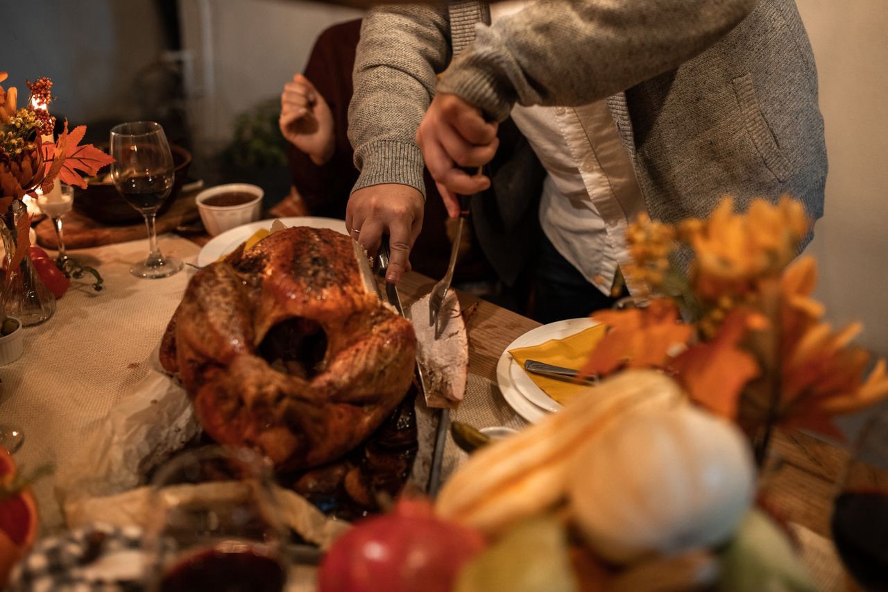 The Thanksgiving Hosting Timeline I Actually Use to Not Lose My Mind 13 Thanksgiving dinner table with turkey and side dishes ready to serve