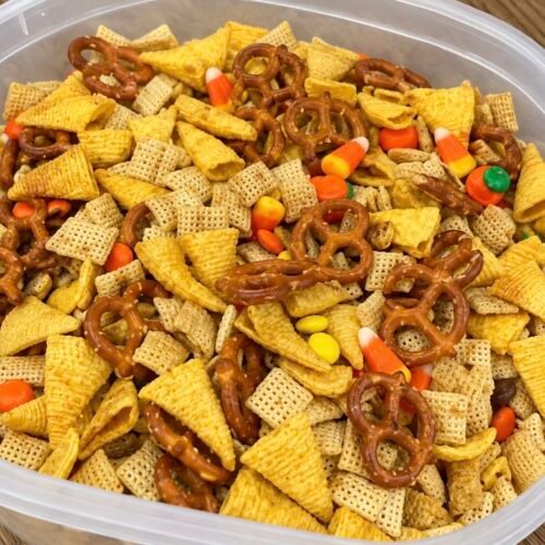 Candy Corn Chex Mix (The Halloween Snack Bowl People Actually Finish) 1 Bowl of candy corn Chex mix with white chocolate coated cereal, pretzels, and M&Ms