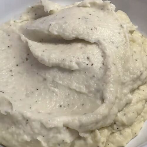 Garlic cauliflower mash topped with parmesan and black pepper
