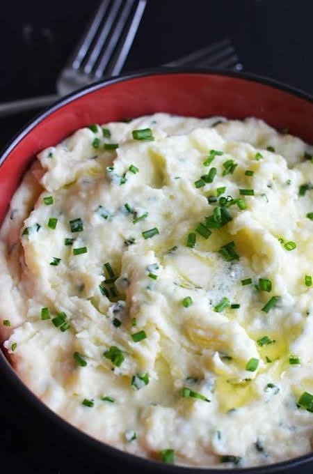 The Budget Christmas Dinner Menu That Doesn't Look Cheap 2 goat cheese mashed potatoes in a serving bowl