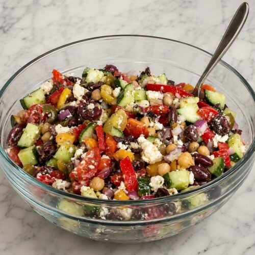 Mediterranean Dense Bean Salad (The BeanTok Recipe I Keep Making) 1 Mediterranean dense bean salad with cannellini beans, chickpeas, cucumber, tomato, kalamata olives, and feta in a lemon-oregano dressing