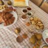 Thanksgiving side dish spread featuring creamed corn, candied yams, and cornbread dressing