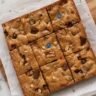 Baked brown sugar cookie bars studded with chopped leftover Halloween candy