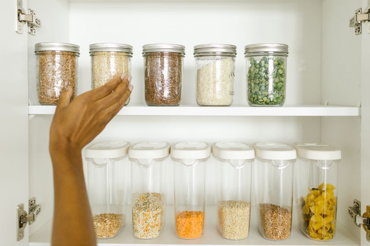 Shelf-stable summer pantry staples including canned tuna, canned beans, and dry pasta