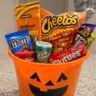 Halloween candy charcuterie board with chocolate bars, gummy worms, and candy corn arranged on a wooden tray