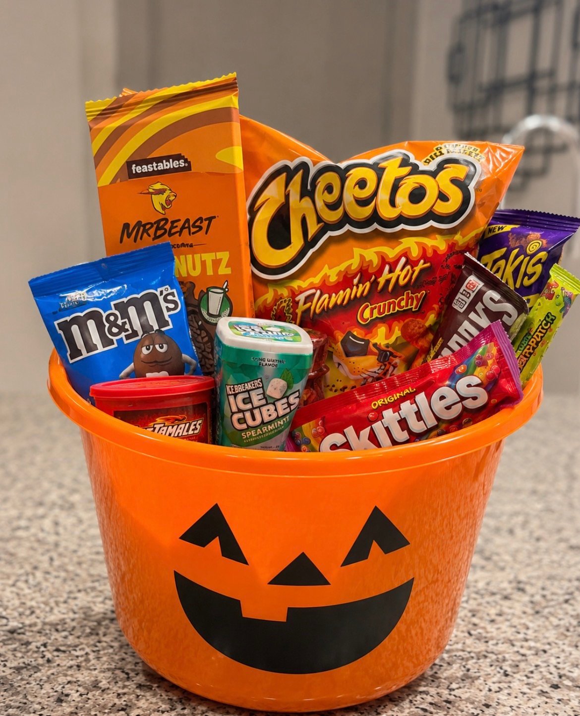 Halloween candy charcuterie board with chocolate bars, gummy worms, and candy corn arranged on a wooden tray