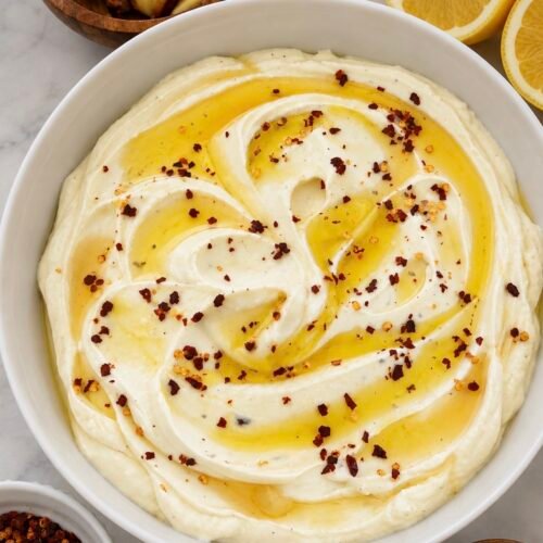 Whipped feta dip swirled on a plate and drizzled with hot honey