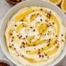 Whipped feta dip swirled on a plate and drizzled with hot honey