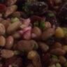 Seven bean salad in a bowl with black beans, chickpeas, cannellini beans, edamame, and lentils tossed in olive oil dressing